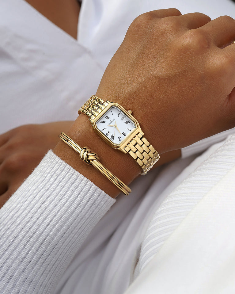 A square womens watch in 22k gold from Waldor & Co. with white Diamond Cut Sapphire Crystal glass dial. Seiko movement. The model is Eternal 22 Bellagio.