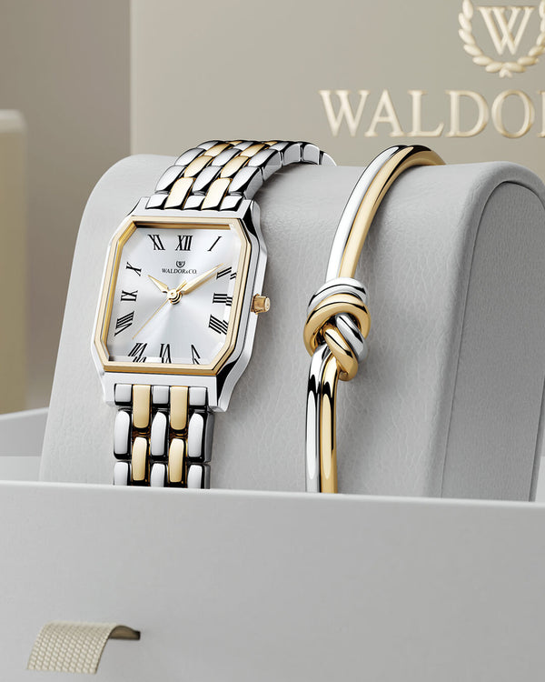 lifestyle_image,A square women’s watch and double knot bracelet in gold and silver from Waldor & co. The model is Eternal 22 Bellagio & Dual Knot Bangle.