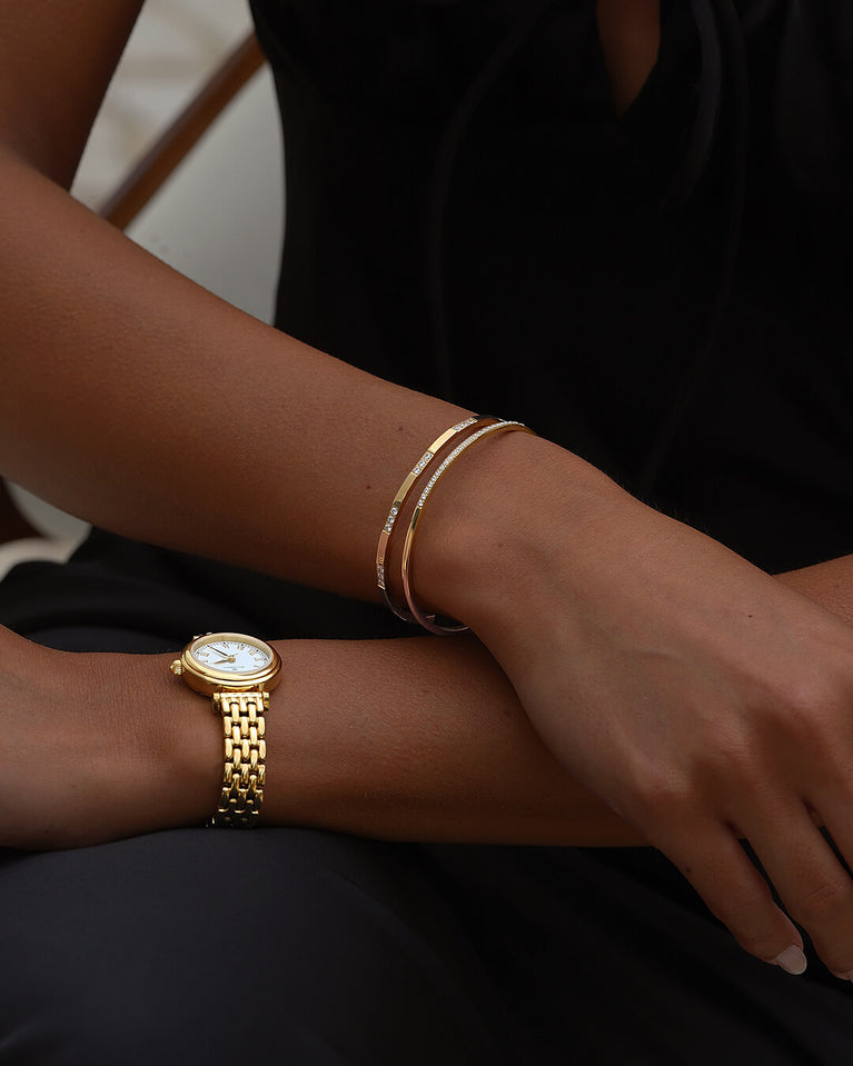 A Bangle in 14k gold-plated 316L stainless steel from Waldor & Co. One size. The model is Bliss Bangle Polished.