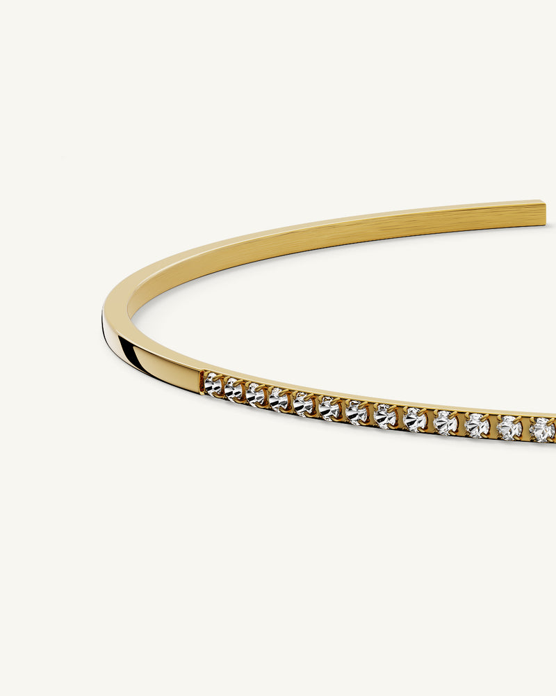 A Bangle in 14k gold-plated 316L stainless steel from Waldor & Co. One size. The model is Bliss Bangle Polished.