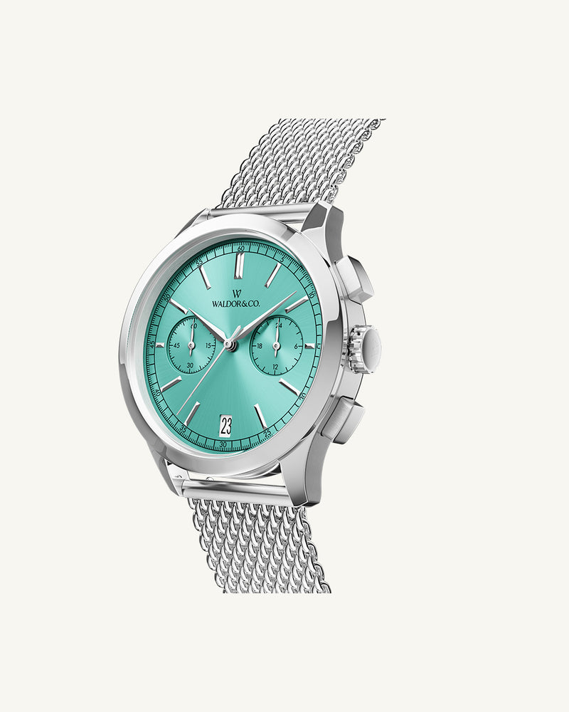 A round mens watch in rhodium-plated silver from Waldor & Co. with turquoise sunray dial and a second hand. Seiko movement. The model is Chrono 44 Sardinia 44mm.