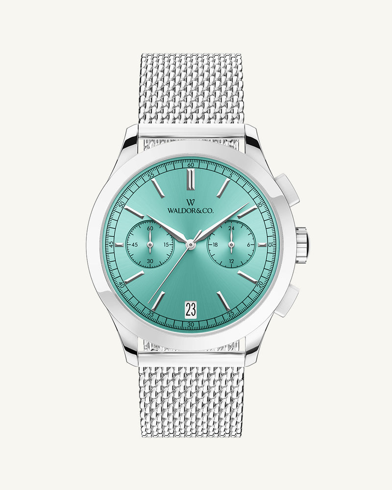 A round mens watch in rhodium-plated silver from Waldor & Co. with turquoise sunray dial and a second hand. Seiko movement. The model is Chrono 44 Sardinia 44mm.