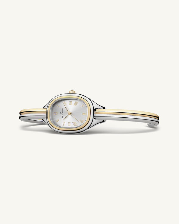 An ellipse shaped womens watch in Rhodium-plated 316L stainless steel from Waldor & Co. with silver sunray dial in brass. Mineral glass with sapphire crystal coating. Seiko movement. The model is Dual Bangle Watch.