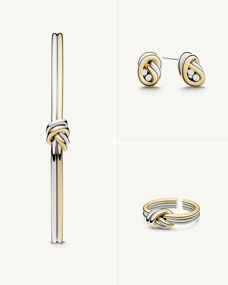 A polished stainless steel ring in 14k gold from Waldor & Co. One size. The model is Dual Knot Ring.