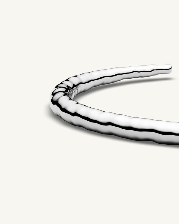 A Round Bangle in 925 Sterling Silver from Waldor & Co. The model is Opal Bangle Sterling Silver