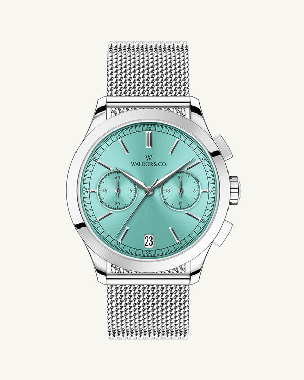 A round mens watch in rhodium-plated silver from Waldor & Co. with turquoise sunray dial and a second hand. Seiko movement. The model is Chrono 44 Sardinia 44mm.