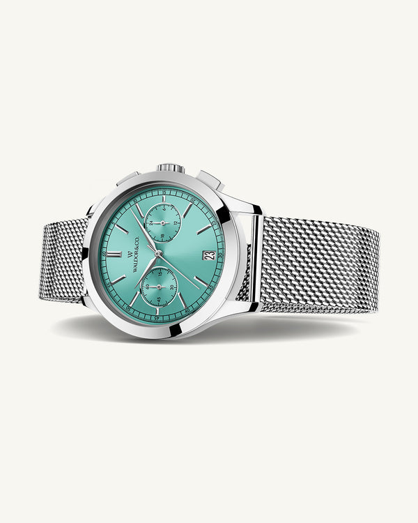 A round mens watch in rhodium-plated silver from Waldor & Co. with turquoise sunray dial and a second hand. Seiko movement. The model is Chrono 44 Sardinia 44mm.