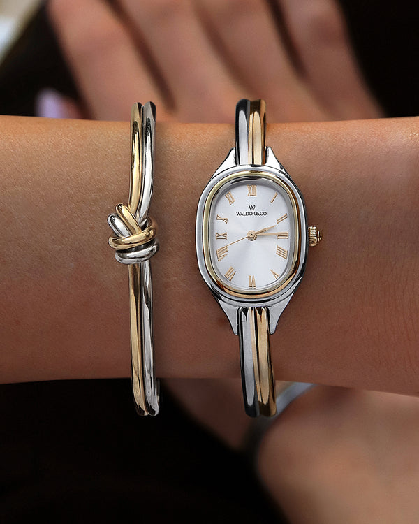 An ellipse shaped womens watch in Rhodium-plated 316L stainless steel from Waldor & Co. with silver sunray dial in brass. Mineral glass with sapphire crystal coating. Seiko movement. The model is Dual Bangle Watch.