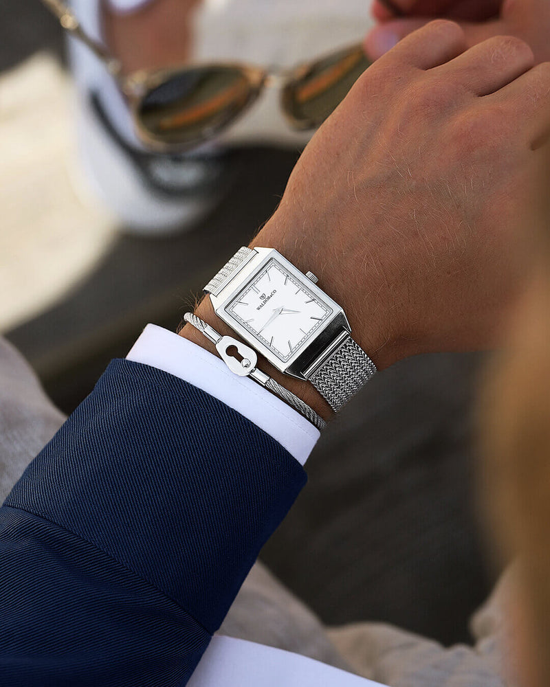 A square mens watch in rhodium-plated silver from Waldor & Co. with white sunray dial. Seiko movement. The model is Conceptual 37 Antibes.